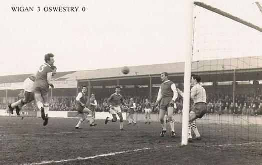 Harry Lyon latches on to a Walter Stanley (third from right) cross. Carl Davenport lurks for any rebounds.  Photo courtesy of WiganWorld. 