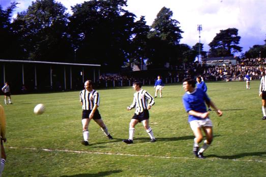 Geoff Davies attacks as ex-Latics player Alf Craig (left) looks on. Kenny Morris and Doug Coutts watch from defence and Bobby Todd from midfield.